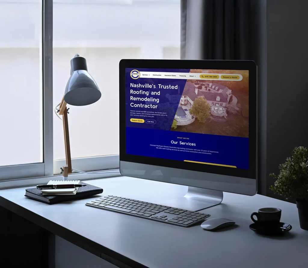Computer on desk showing Intercept Roofing website